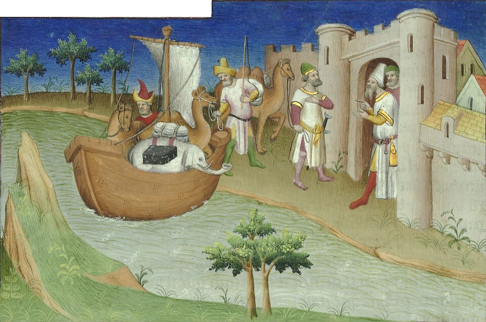 A French manuscript miniature of a walled port with elephants and laden camels arriving, ships at anchor beyond, painted in bright gold and blue.