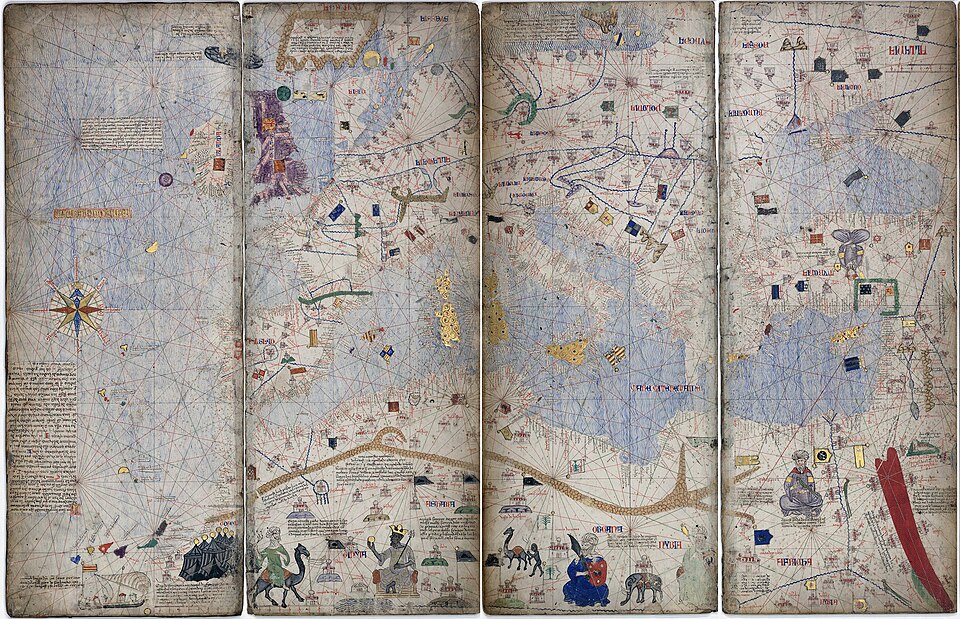 A panel of an illuminated portolan atlas showing Europe, dense with red and gold place names, rhumb lines radiating from compass roses across the sea.